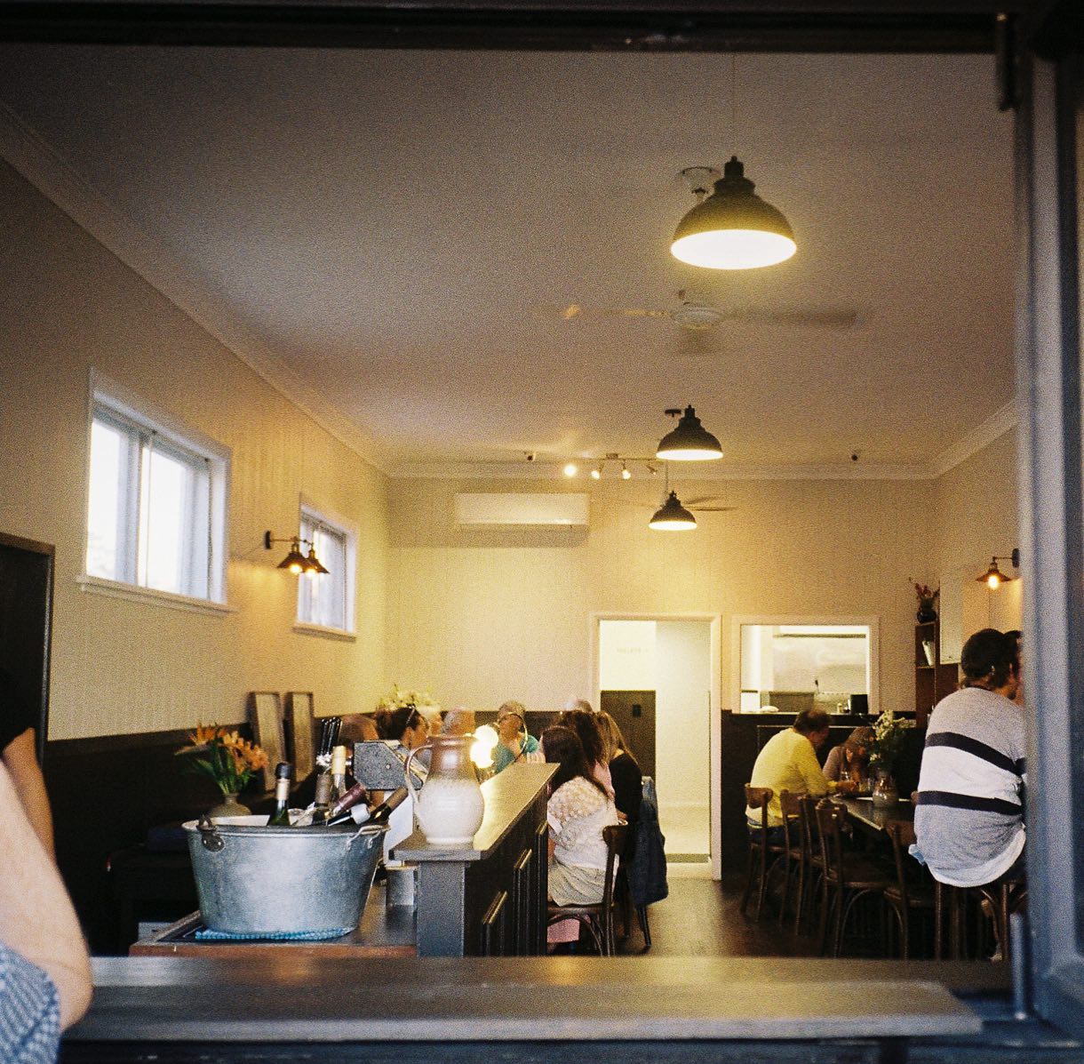 Inside Orchard, warm evening light over the bar